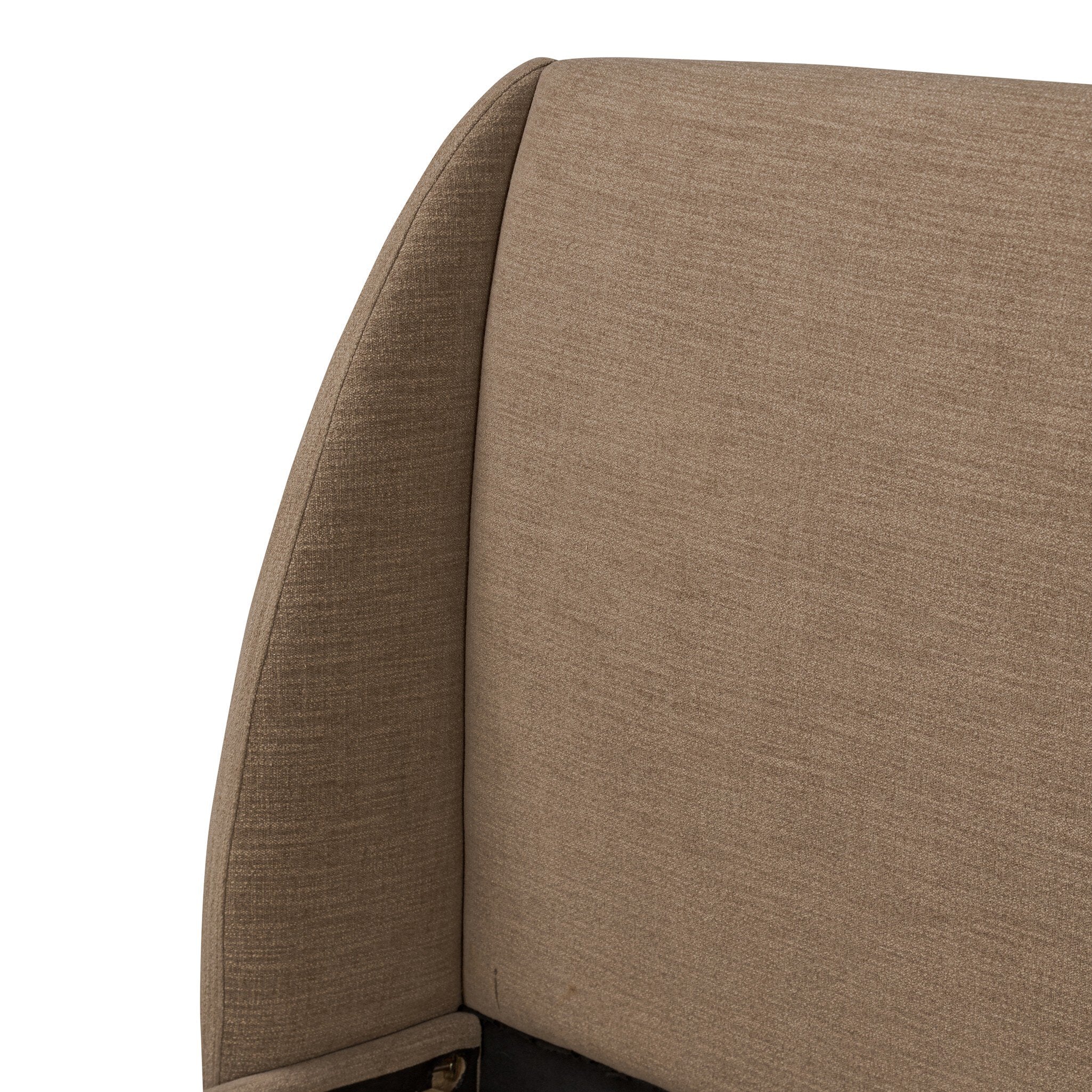 Close up of a taupe upholstered bed with white bedding on a white background.