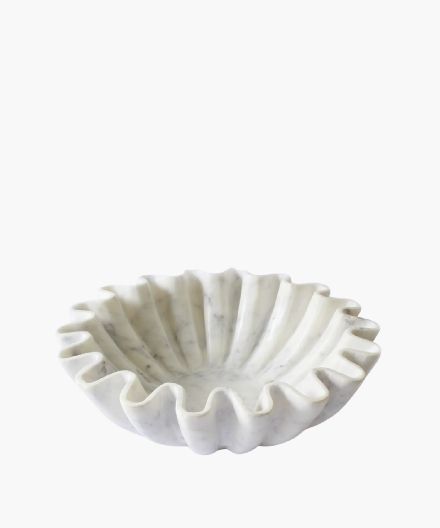 A white, wavy marble bowl with a ruffled edge, resembling a flower. The smooth texture and elegant design convey a sense of sophistication. | S.W. Home