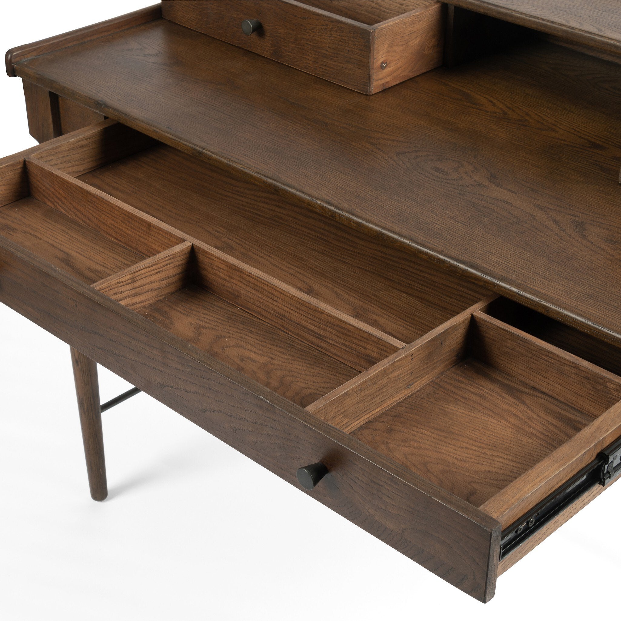 Close up of a wooden desk with drawers on a white background.