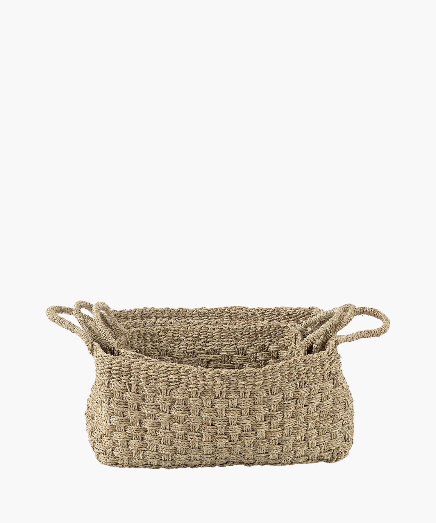 Three rectangular seagrass woven baskets in various sizes with two looped handles, made of natural fibers in a textured, checkerboard pattern. The tone is earthy and rustic. | S.W. Home