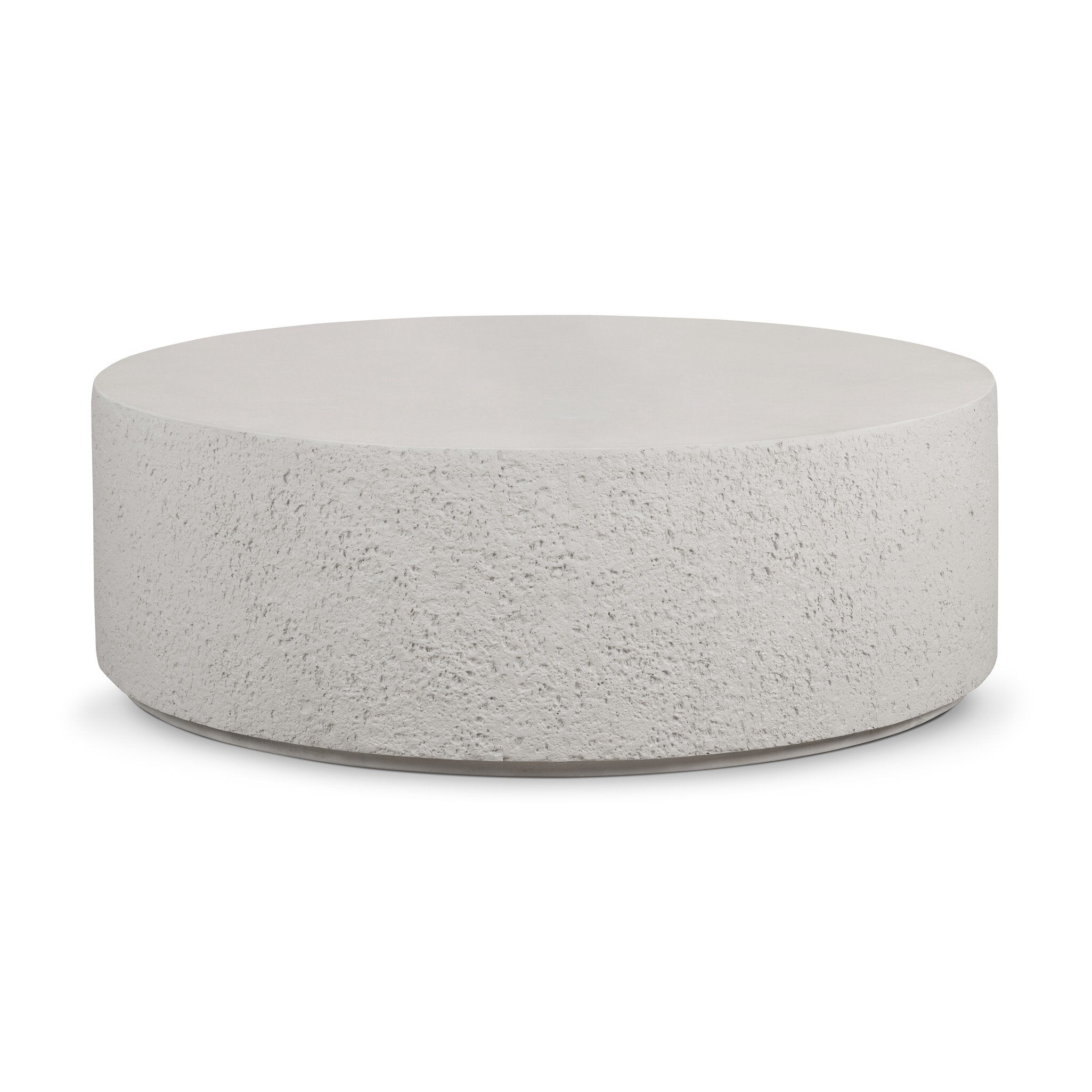 Round concrete coffee table with raw edges and a smooth top on a white background. | S.W. Home
