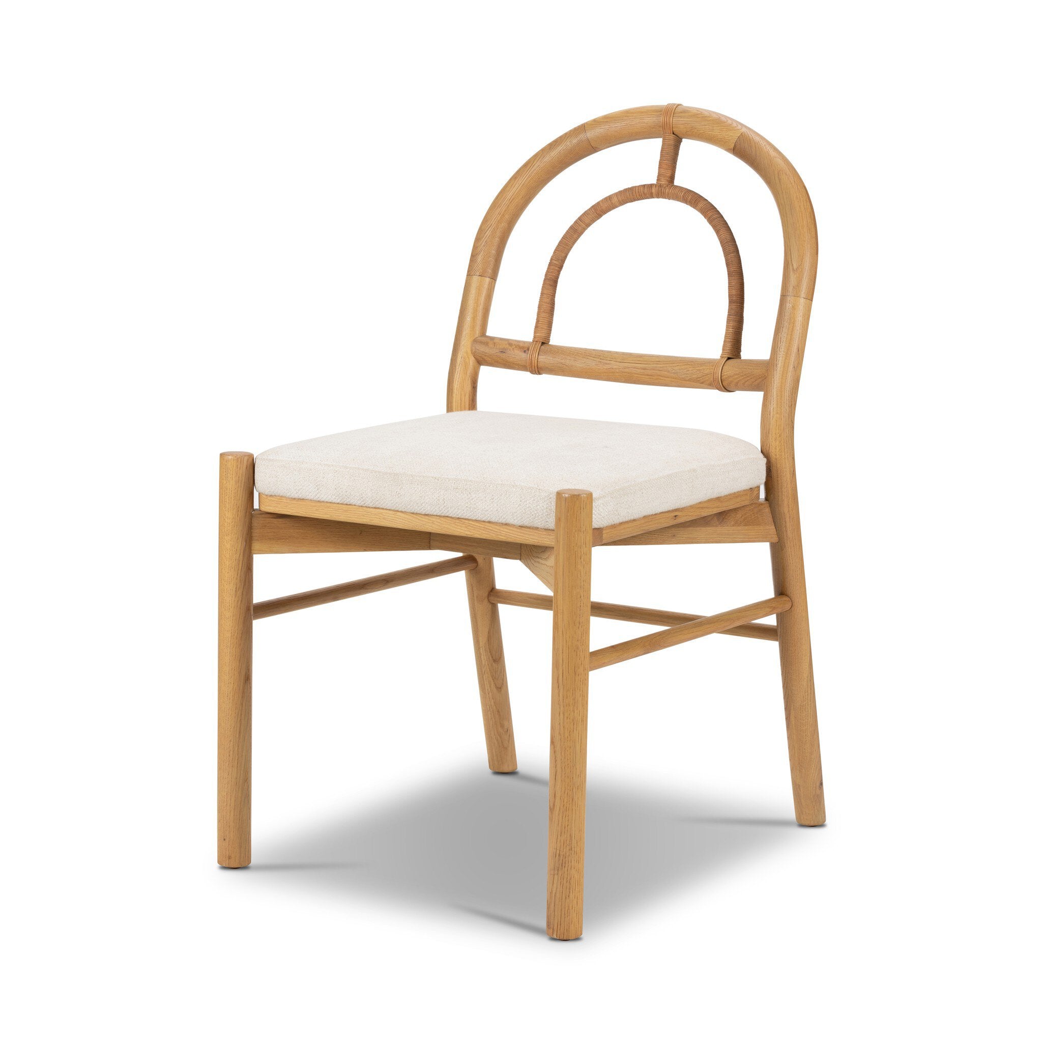 Solid oak dining chair with an arched frame, hand-wrapped cane back detailing, and an upholstered drop-in seat. 