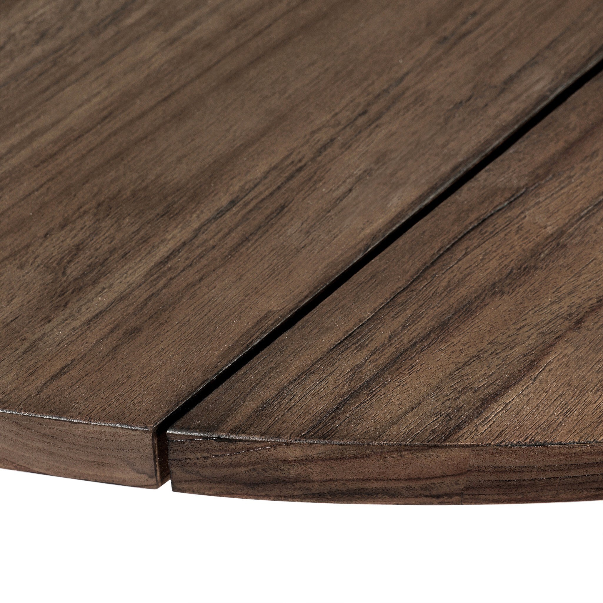 Close up of the round top of the teak dining table showing the color and grain. 