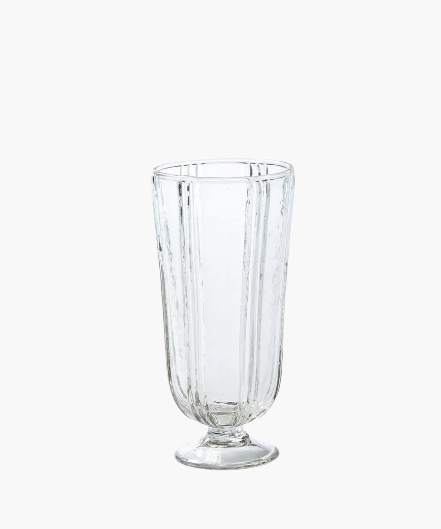 Clear glass tumbler with a textured, vertical ripple pattern. The glass is set on a short pedestal base, conveying a classic and elegant tone. | S.W. Home