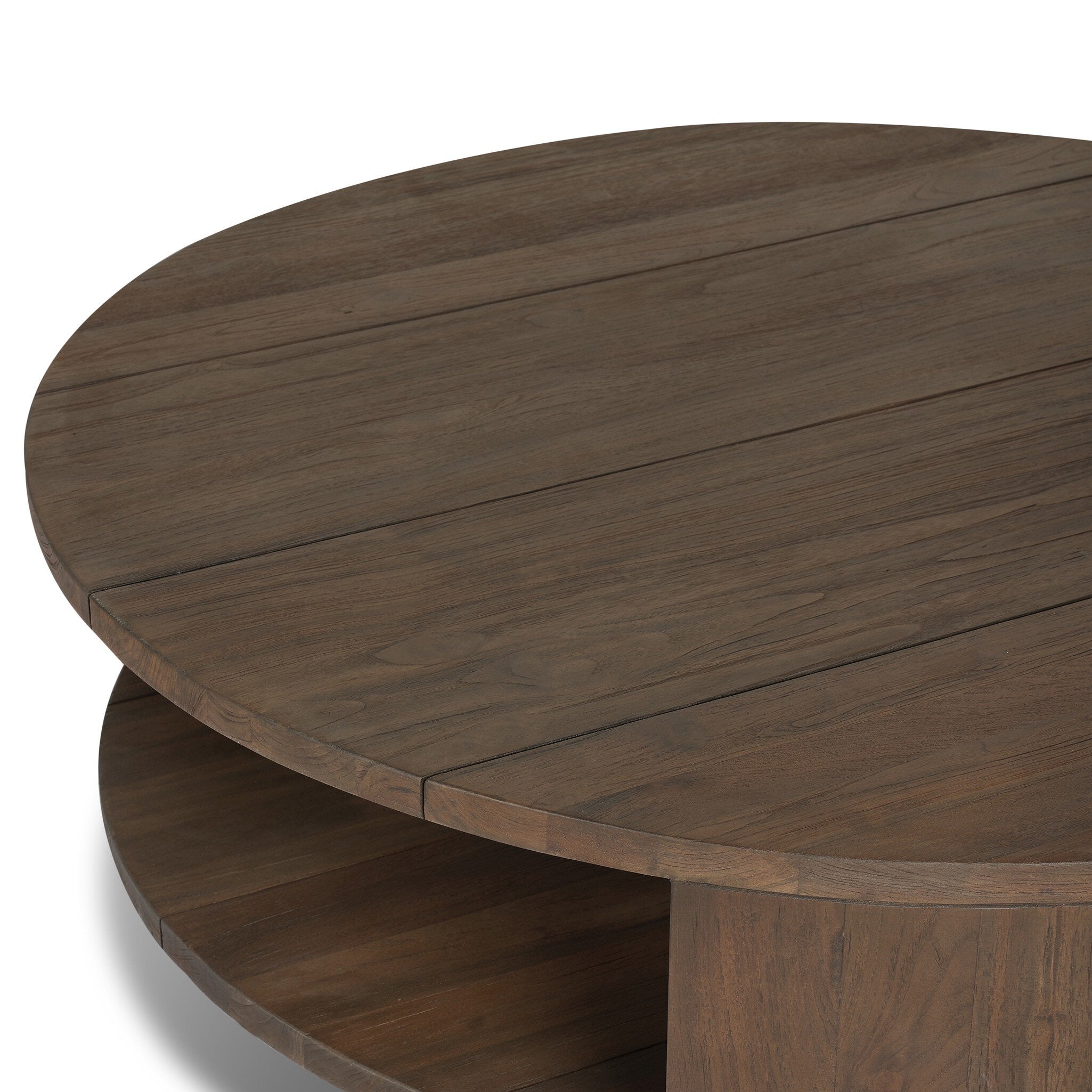 A two tiered round coffee table made from reclaimed wood with chunky legs and a brown finish.