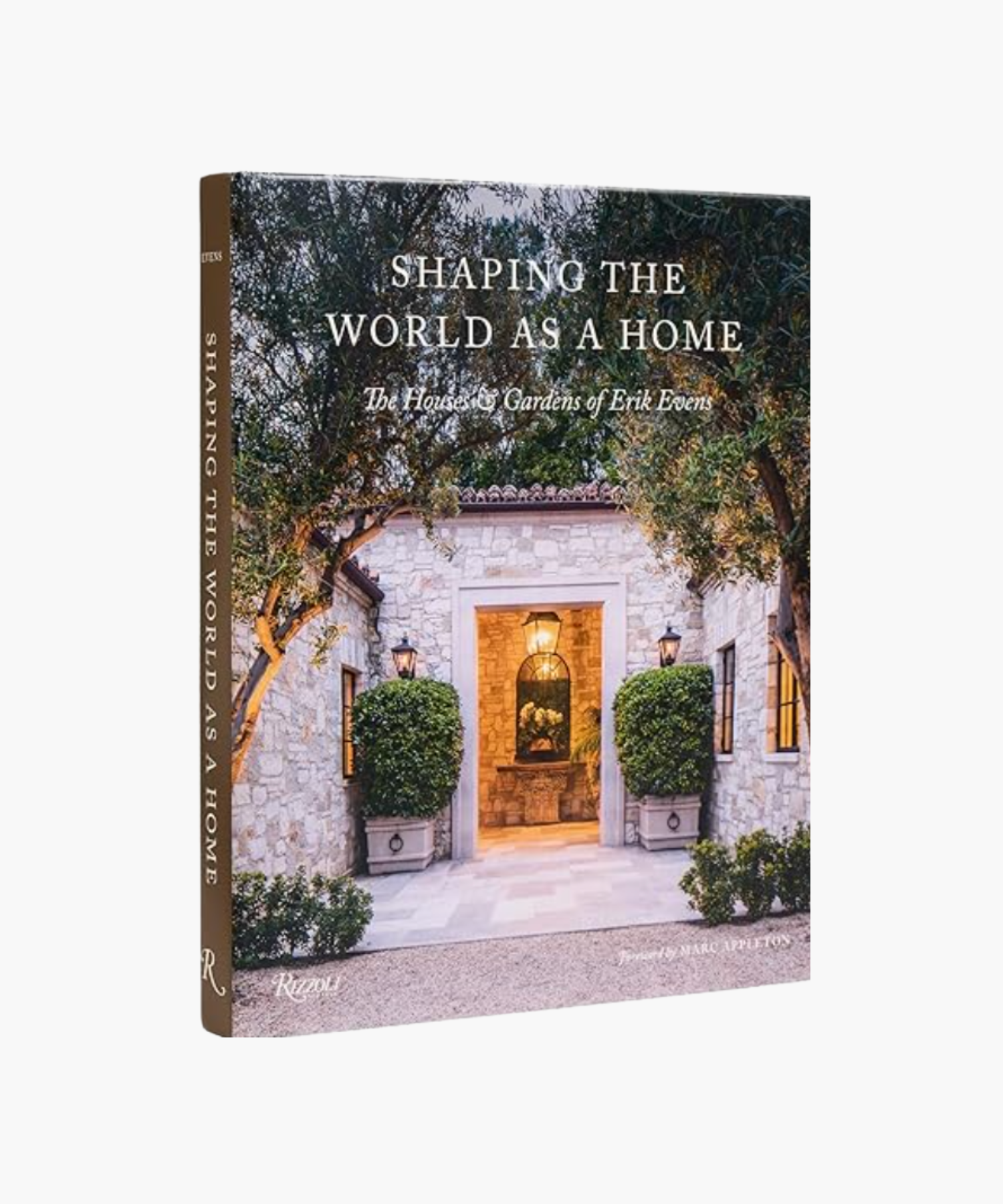 Book cover titled "Shaping the World as a Home," features a stone house entrance framed by lush greenery and lanterns, conveying elegance and warmth. | S.W. Home