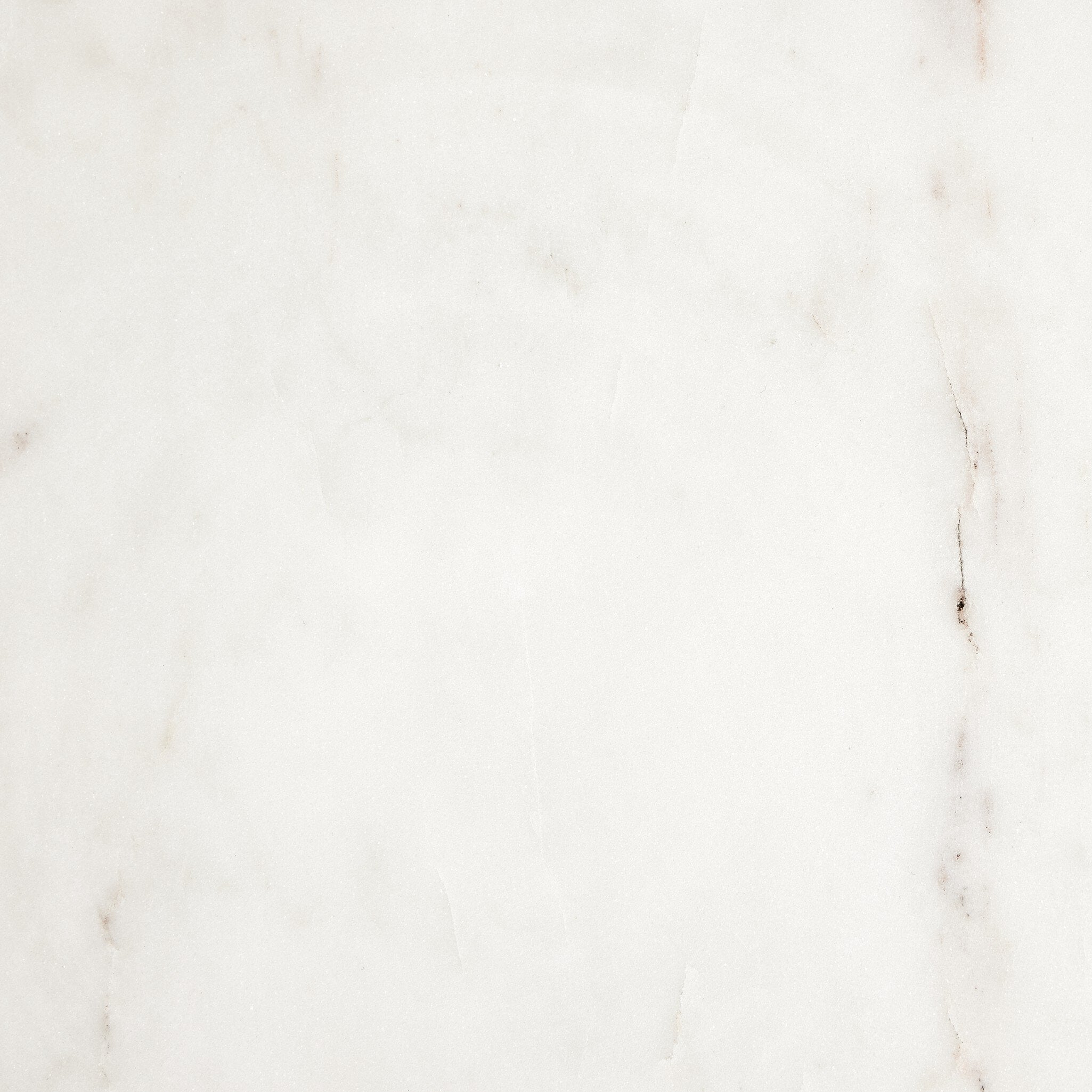 Close-up of the white marble end table showing its color and subtle veining. 