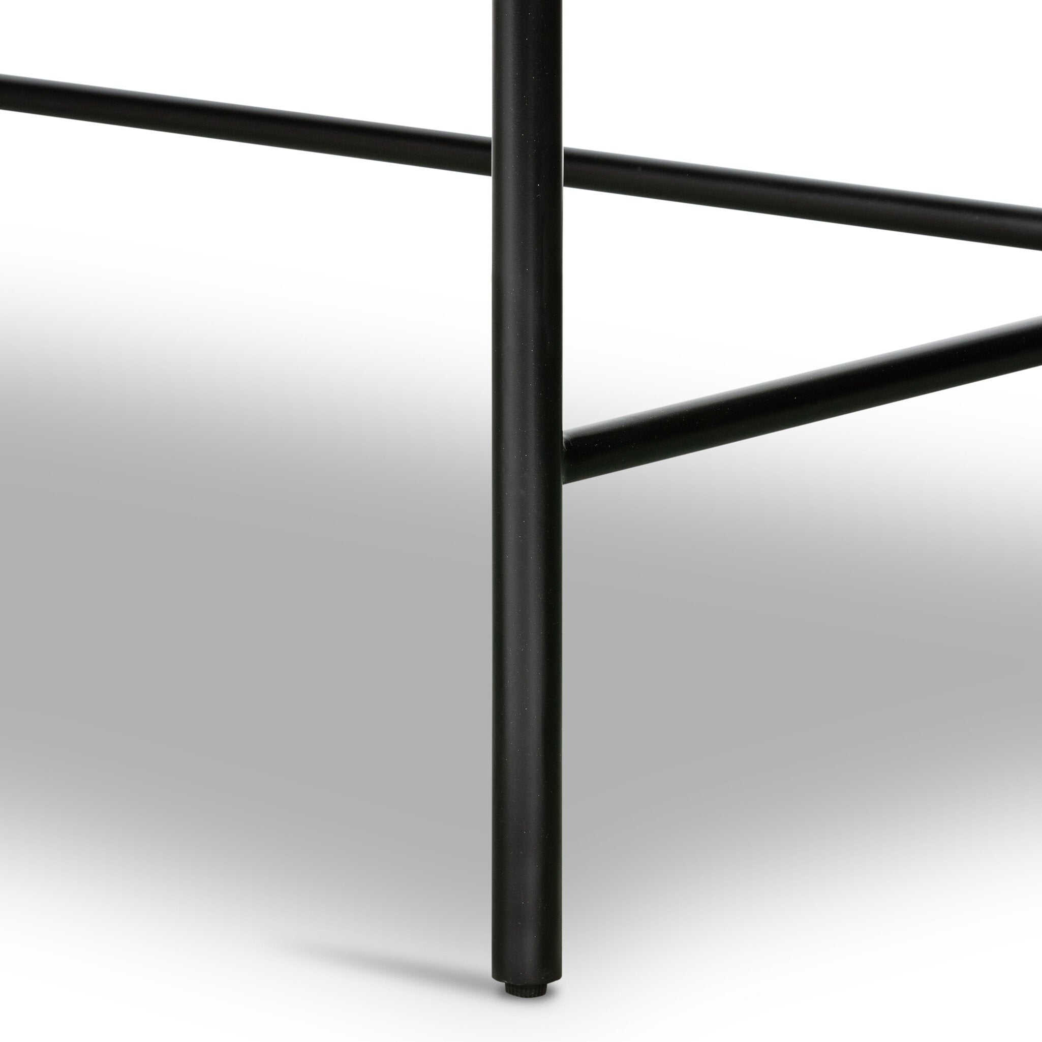 Close up of a black desk with a drawer and gold handle on a white background.