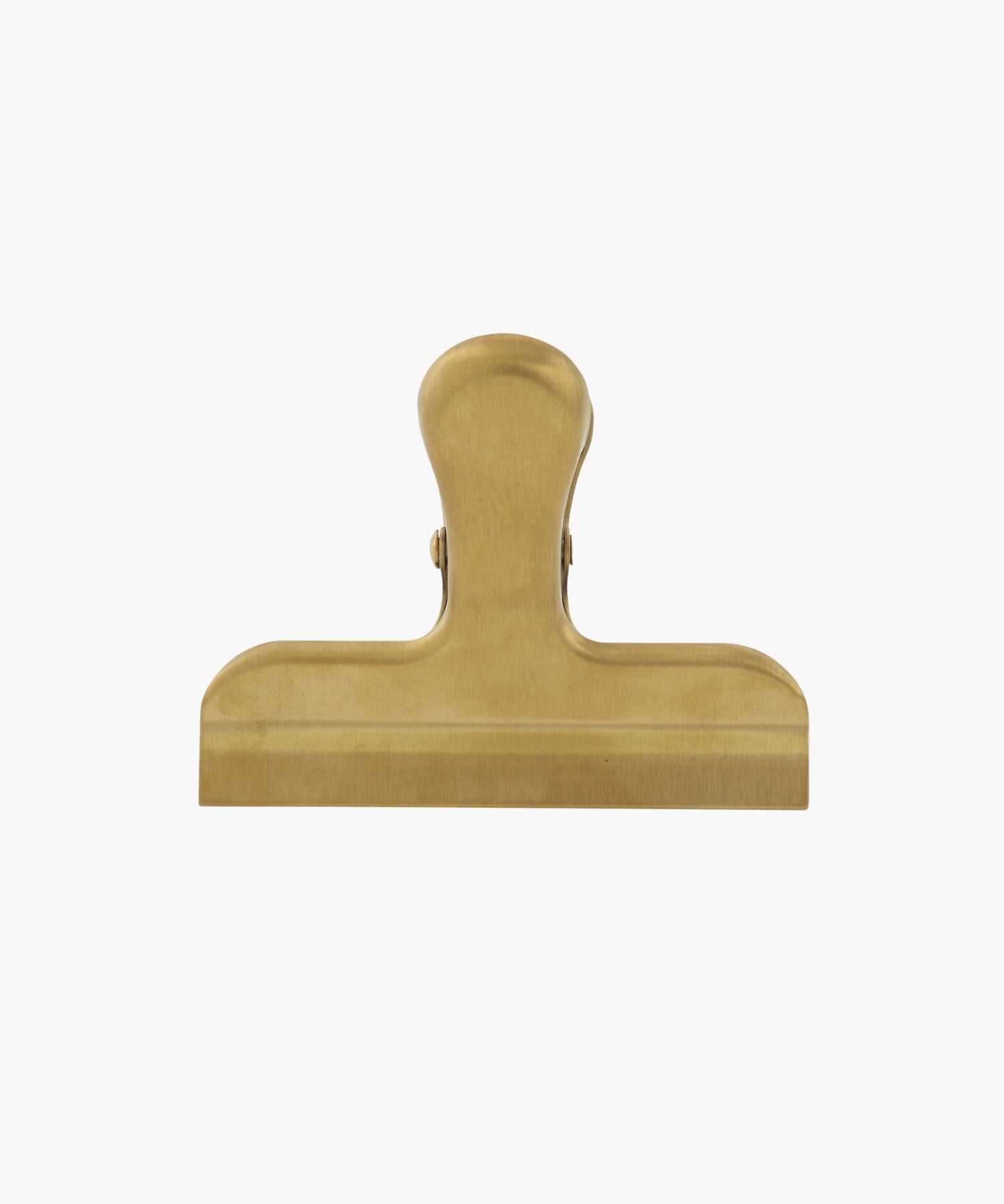 A gold-colored metal binder clip. The clip is large, with a smooth finish, conveying a utilitarian feel. | S.W. Home