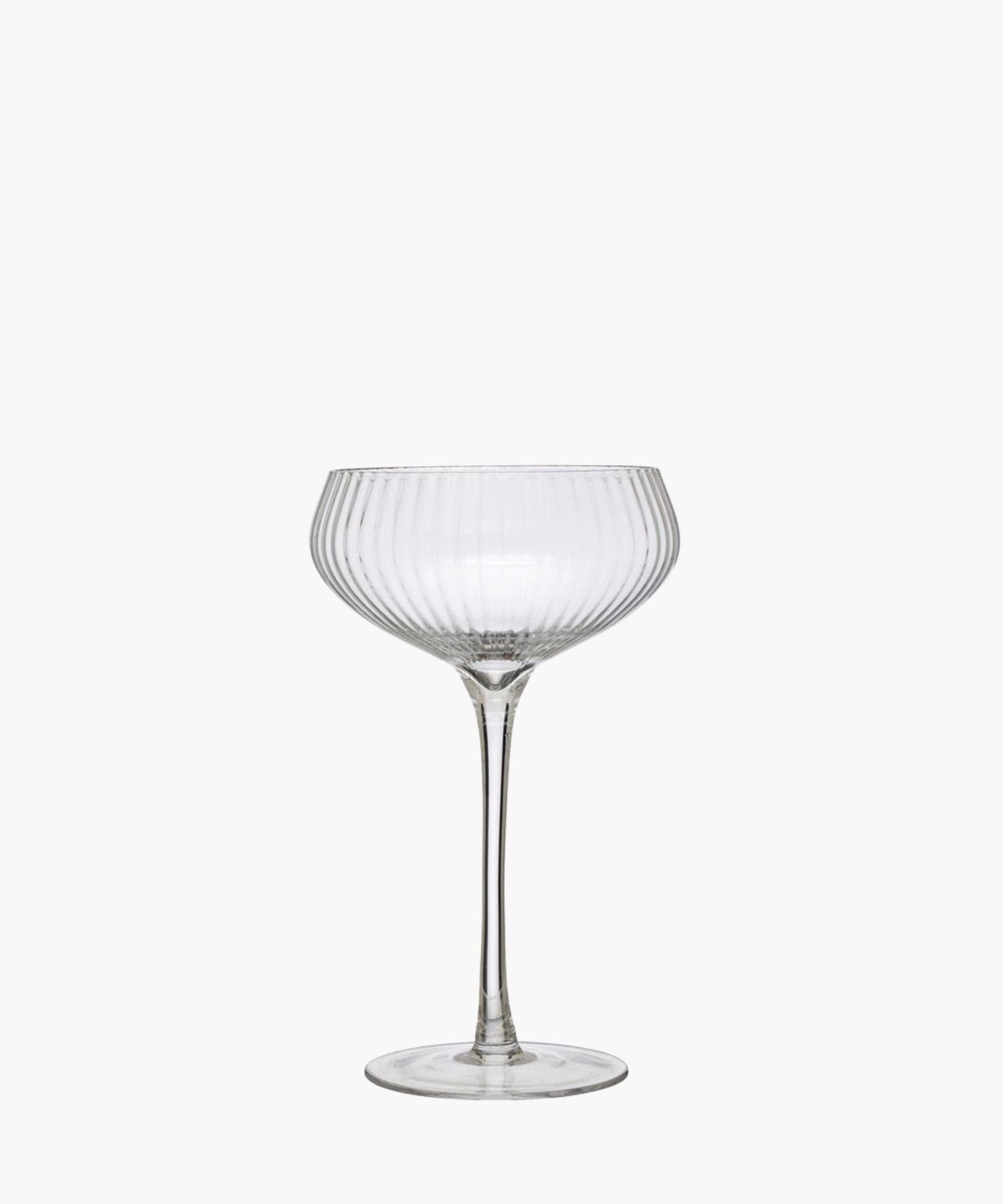 Elegant, clear glass coupe with vertical ridges, featuring a wide, shallow bowl and a tall stem. It exudes sophistication and vintage charm. | S.W. Home