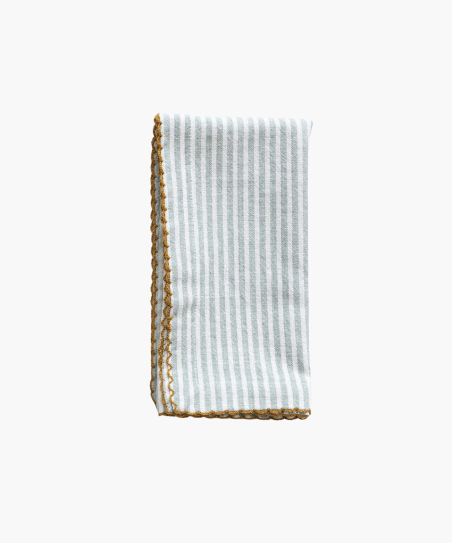 A folded napkin with pale blue vertical stripes and a decorative yellow scalloped edge. The design is simple, evoking a clean, elegant feel. | S.W. Home