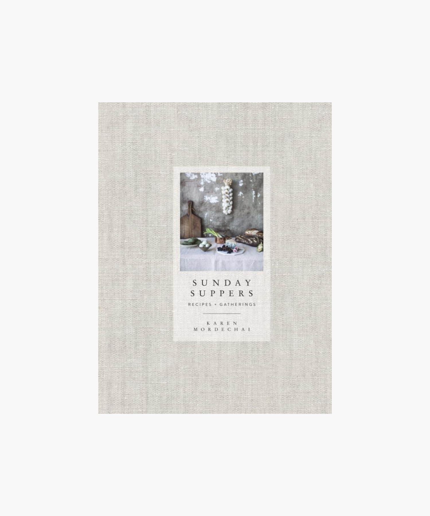 Cookbook cover titled "Sunday Suppers" by Karen Mordechai features rustic kitchen items on a table against a textured wall, evoking a cozy, inviting scene. | S.W. Home