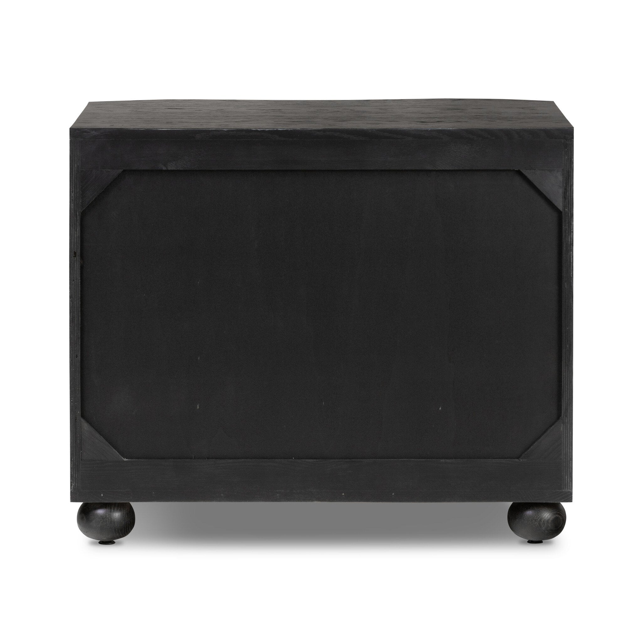 The back of a dark wood dresser with three drawers and round knobs on a white background.