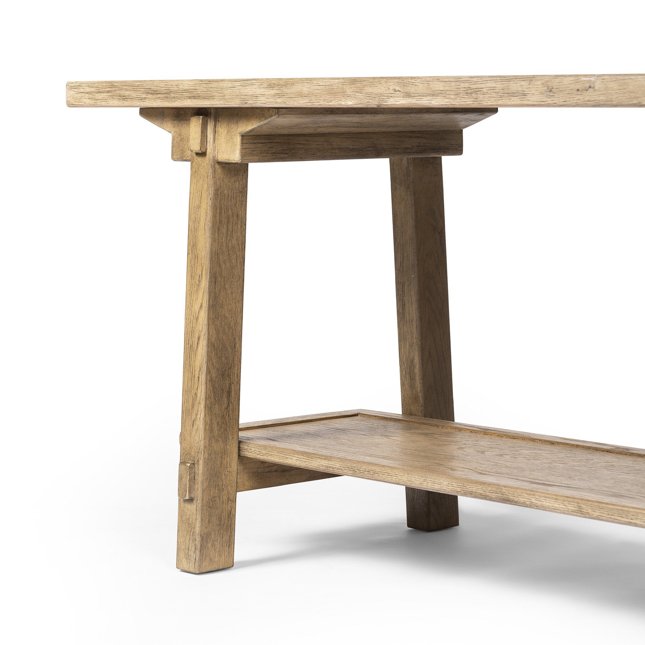 Close up of a wooden console table with a rustic finish on a white background.