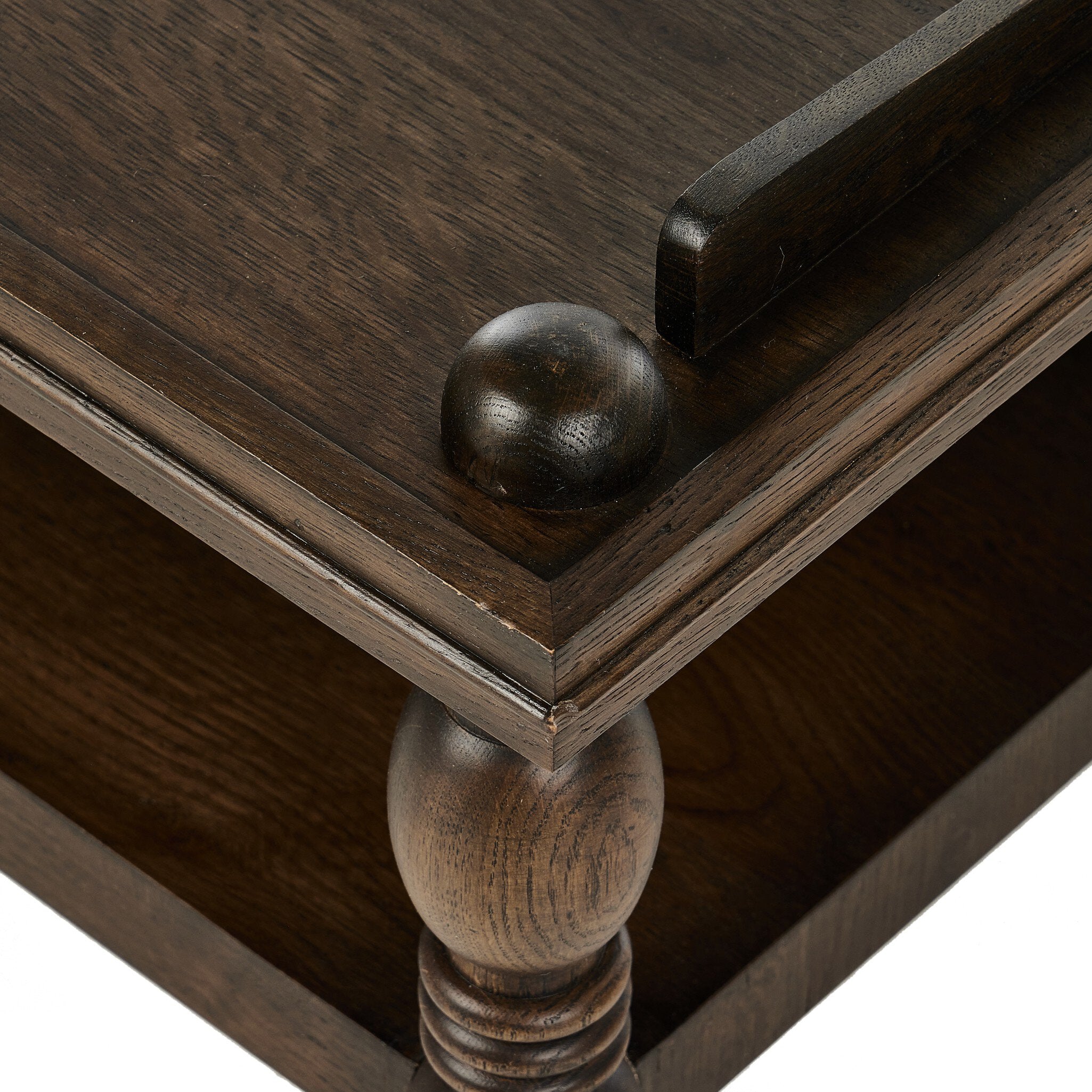Close-up of a wooden coffee table with detailed carvings on a white background