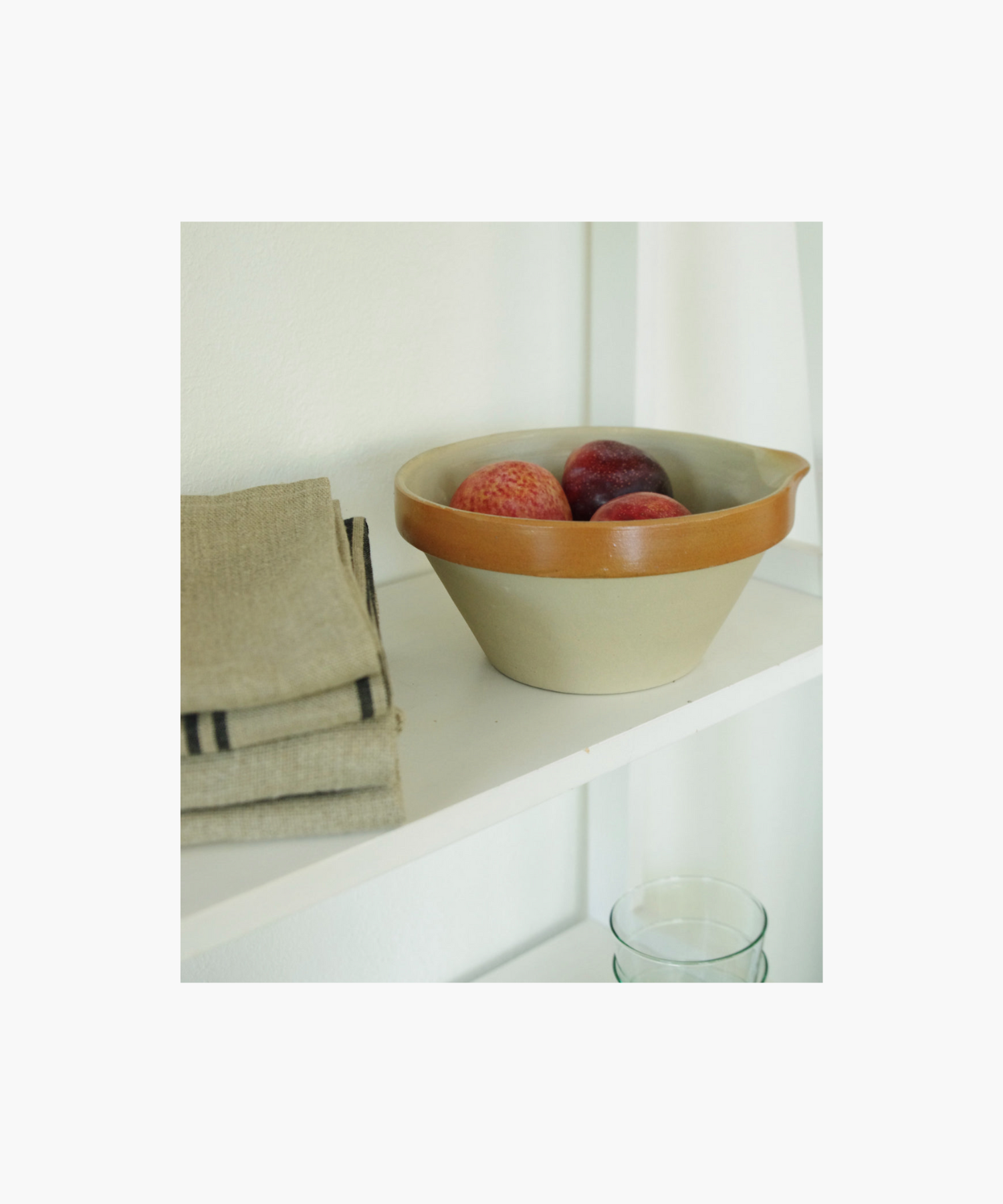 A ceramic bowl with a beige base and a glossy brown rim. The simple and functional design conveys a rustic and practical tone. | Wildwood Home Co.