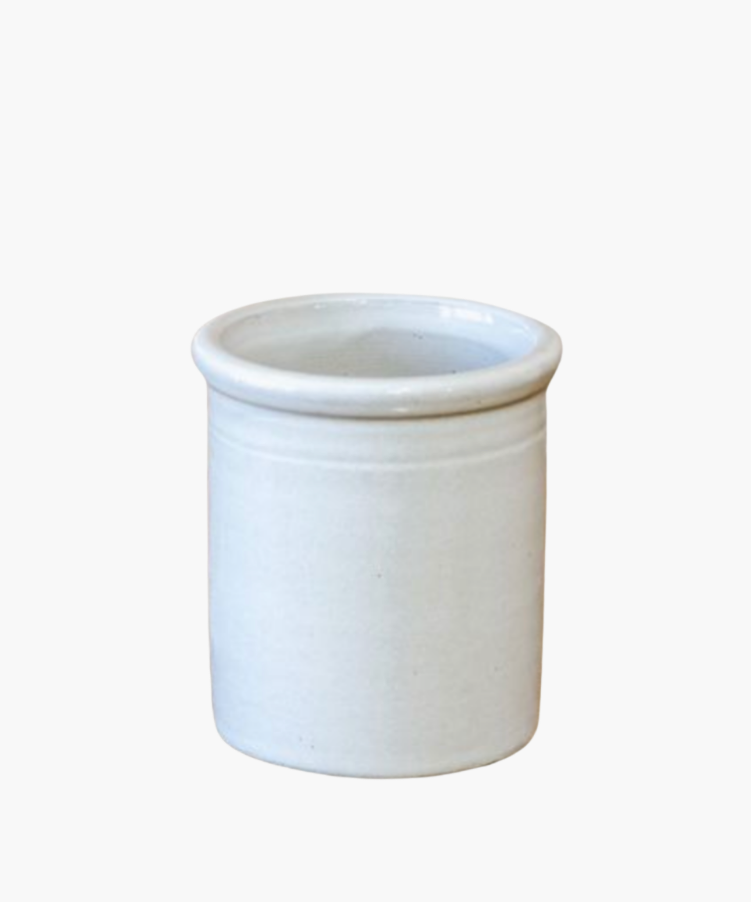 Simple white ceramic pot with a smooth finish, featuring a slightly raised rim. The image conveys a minimalist and clean aesthetic. | Wildwood Home Co.