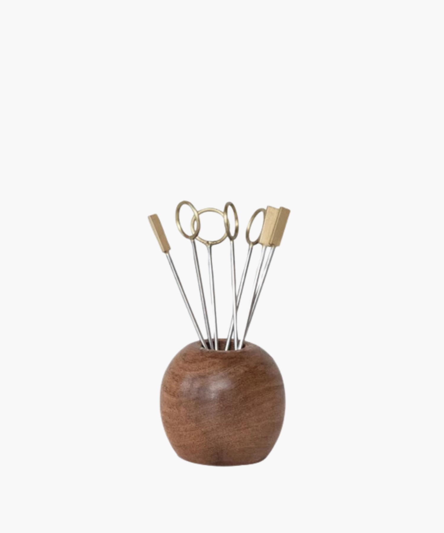 Wooden holder with metal skewers displaying round and rectangular brass tops. Modern, minimalist design conveys elegance and functionality. | S.W. Home