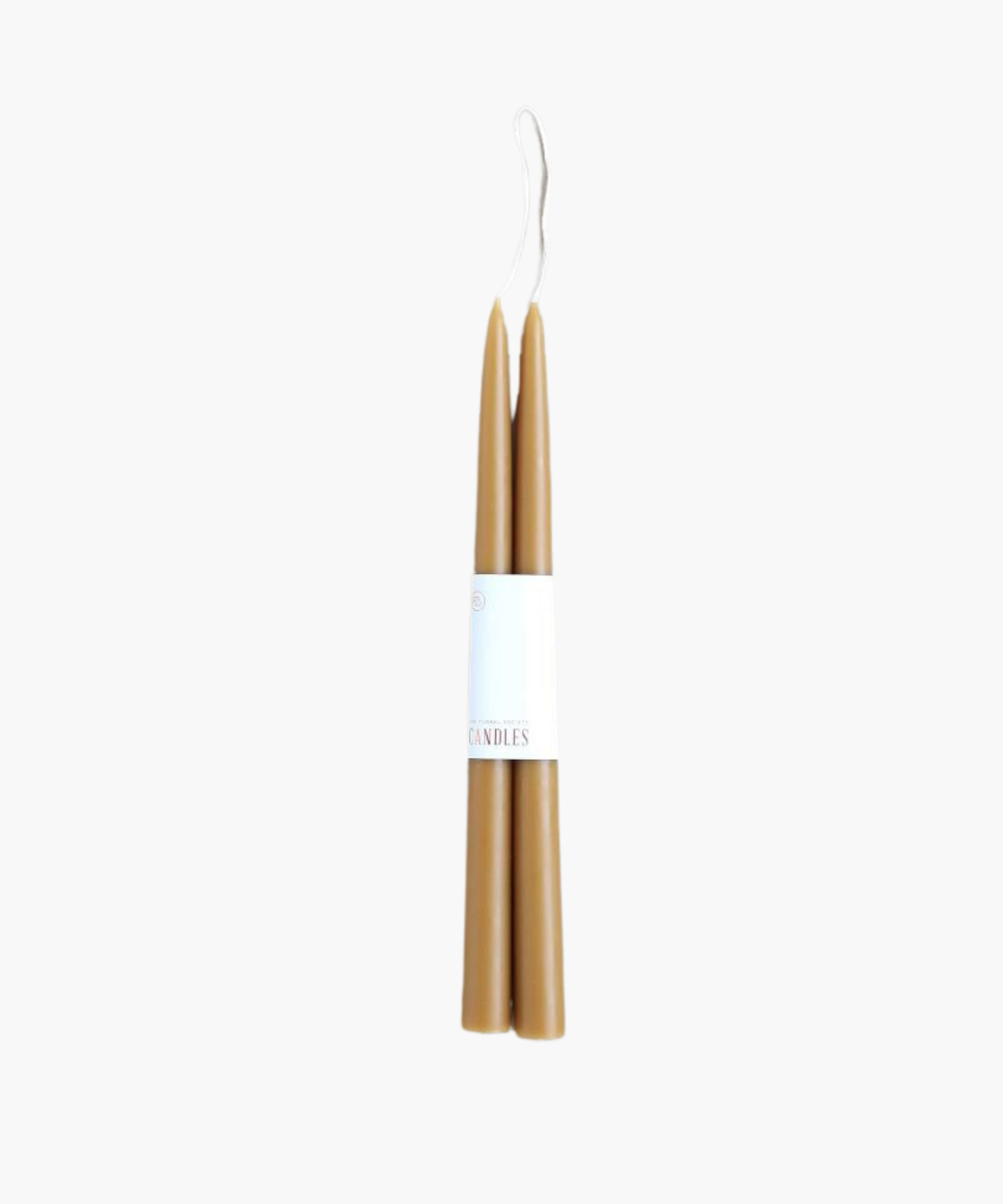 Two brown taper candles bundled together with a white paper label. The wicks are visible at the top. The background is plain white, highlighting the candles' simplicity. | SW Home