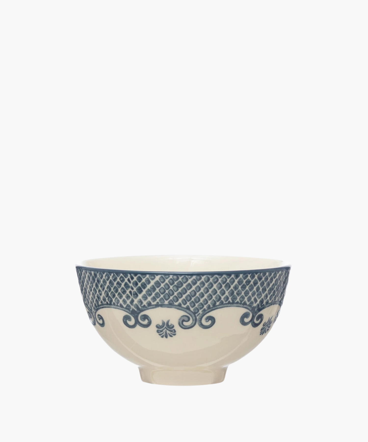 A cream-colored ceramic bowl with ornate blue patterns features lattice and swirl designs, conveying an elegant and vintage aesthetic. | S.W. Home