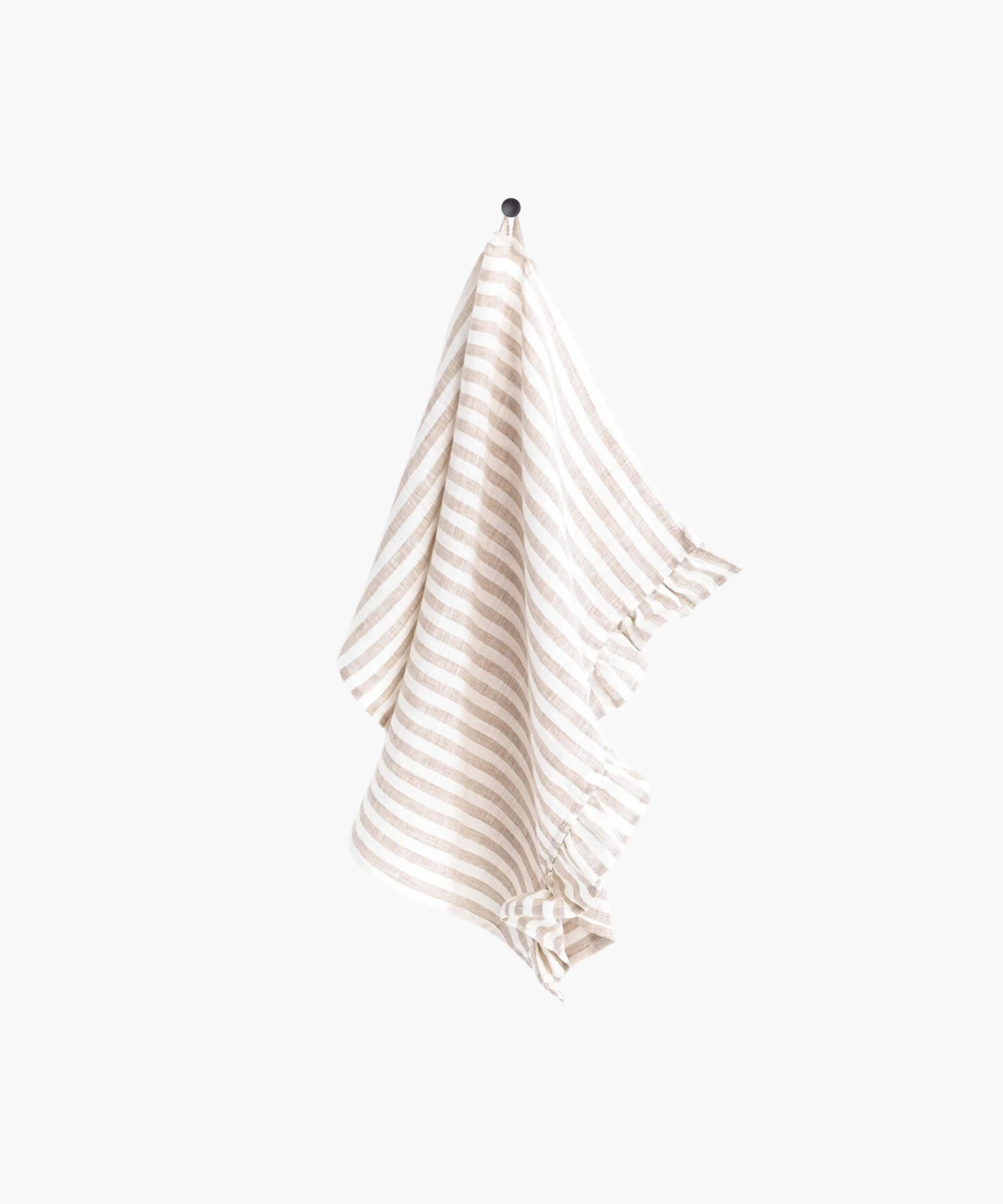A beige and white striped linen tea towel with ruffle trim hangs neatly on a black hook against a plain white background, creating a clean and minimalistic appearance. | S.W. Home