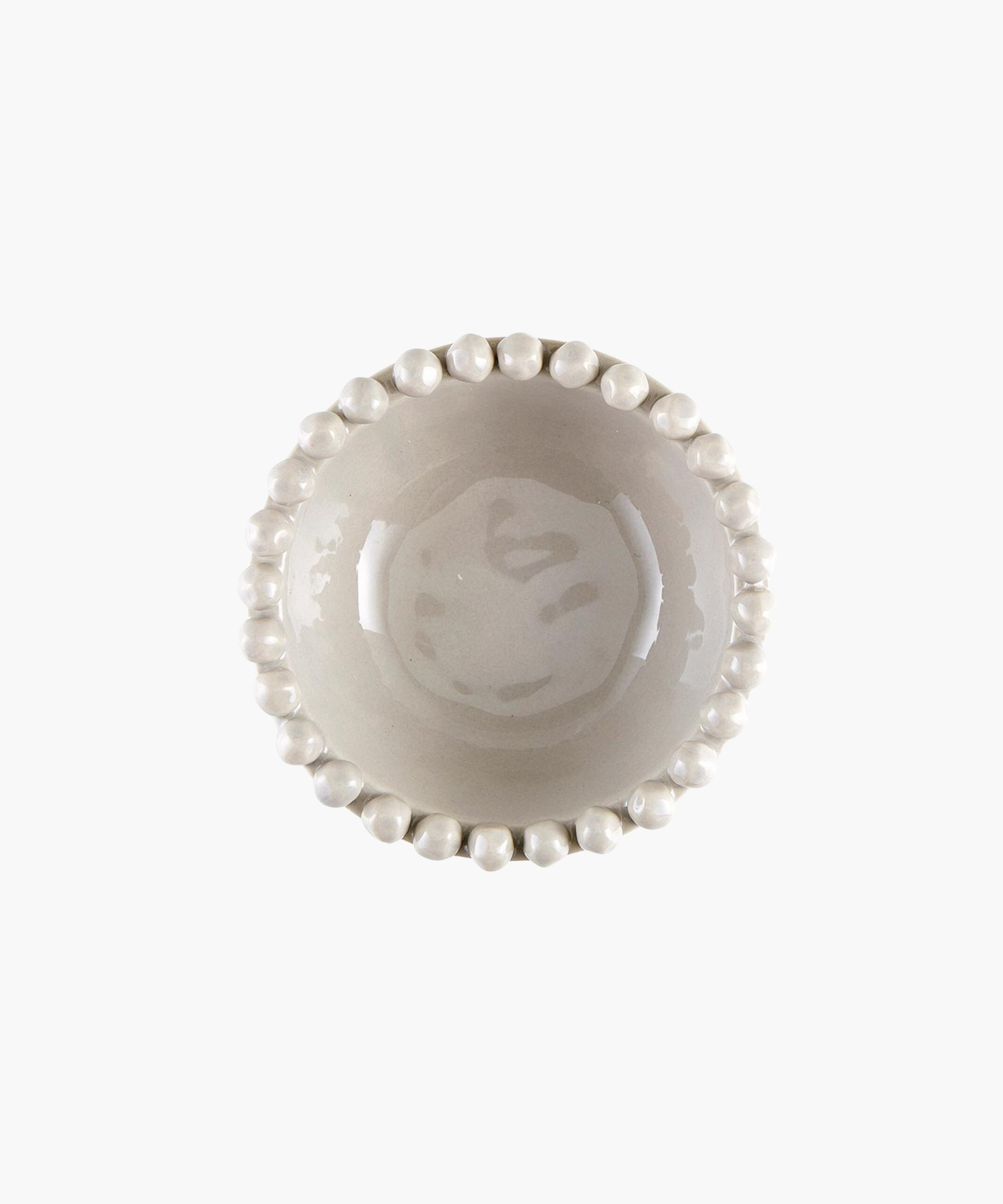 Overhead view of a grey ceramic bowl with a glossy finish, featuring a decorative rim of evenly spaced round knobs. The design is simple yet elegant, conveying minimalism. | Wildwood Home Co.