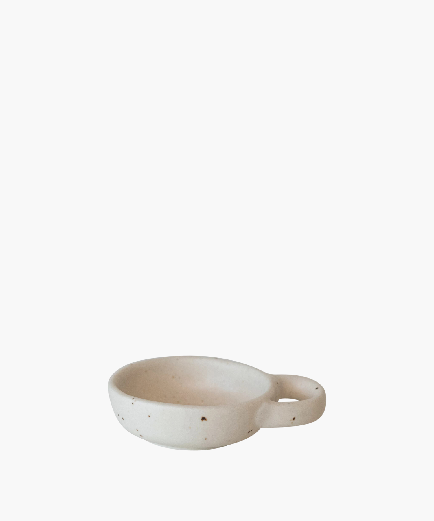 Minimalist ceramic bowl with speckled texture and a round handle on the right side. Its earthy tones convey simplicity and elegance. | S.W. Home