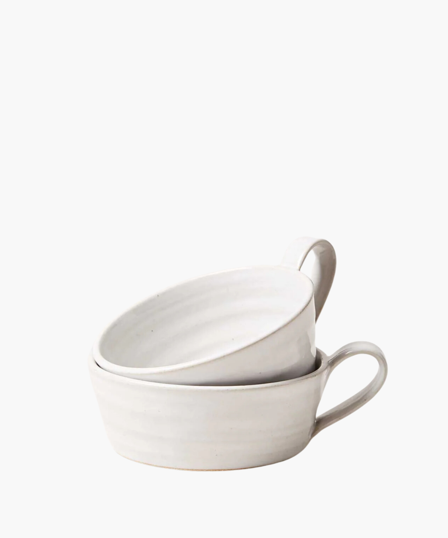 Two simple white ceramic mugs stacked with a single loop handle on the right. The bowl has a smooth, matte finish and conveys a minimalist, elegant design. | S.W. Home