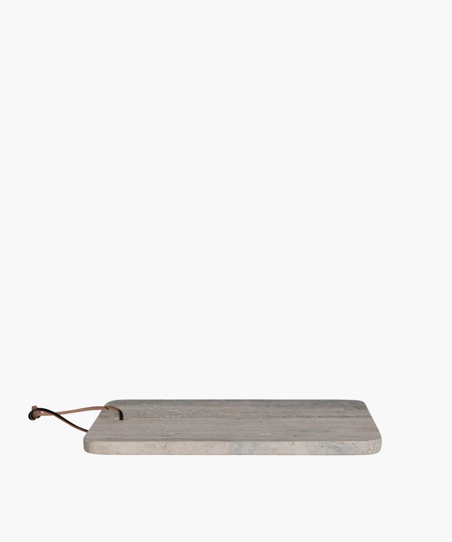 A side profile of a rectangular travertine cutting board with natural gray and beige veining, featuring rounded corners and a leather strap threaded through a hole at the top. | SW Home