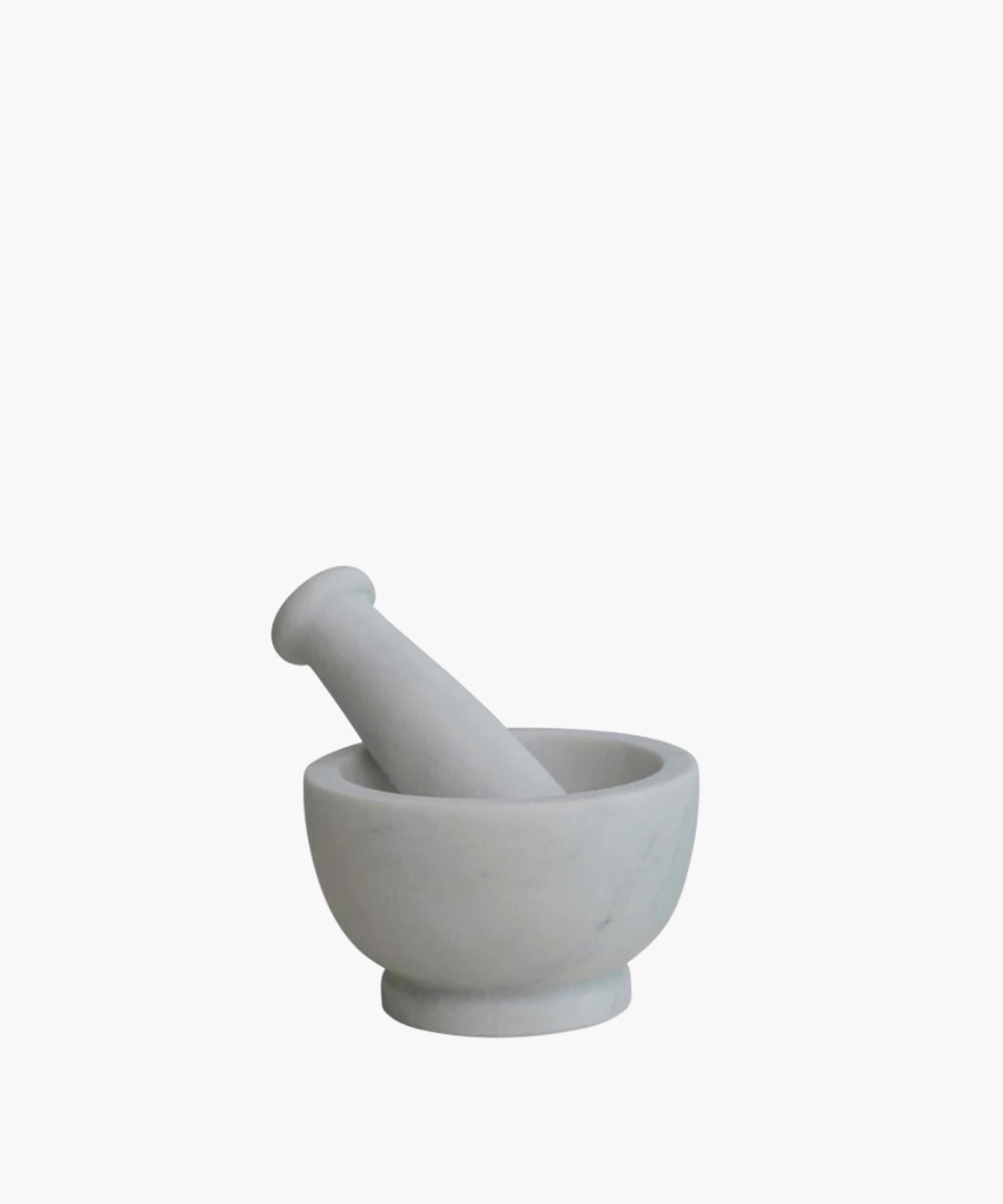 A white marble mortar and pestle set on a plain background. The smooth, round design conveys a sense of elegance and simplicity, ideal for grinding. | Wildwood Home Co.